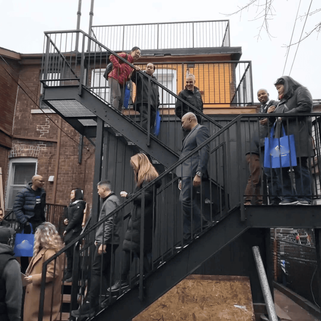 People socializing outside residential building.