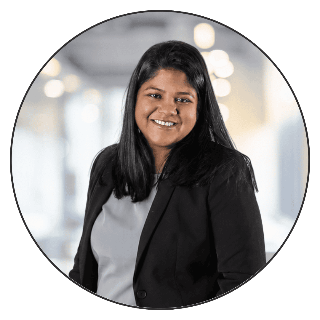 Professional woman in business attire smiling for real estate investing.